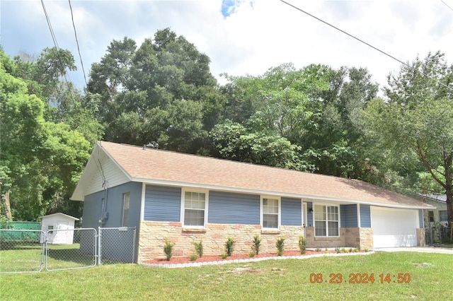 view of front facade with a front yard and a garage