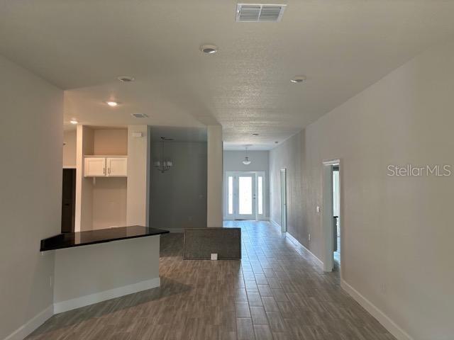 kitchen with hardwood / wood-style flooring and white cabinetry