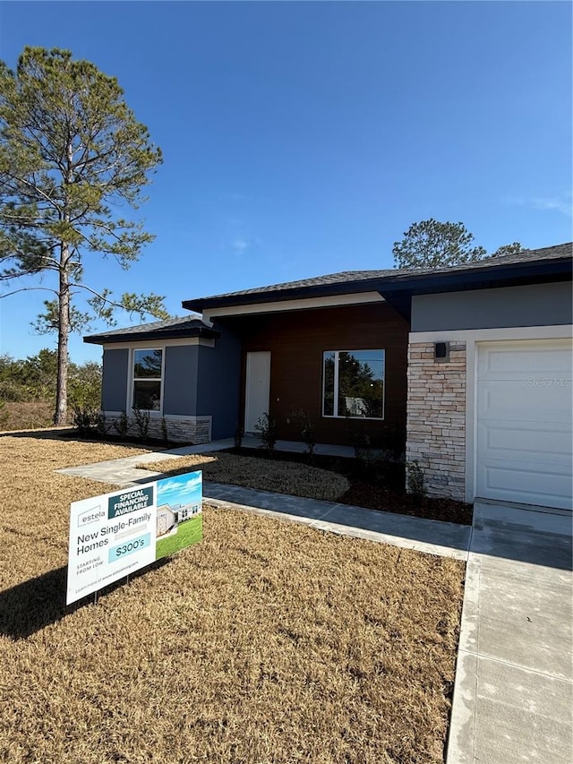 view of front of property with a garage and a front yard