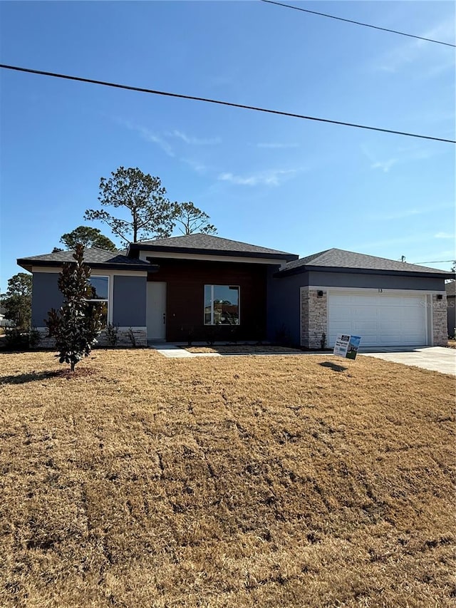 view of front of home with a garage and a front yard