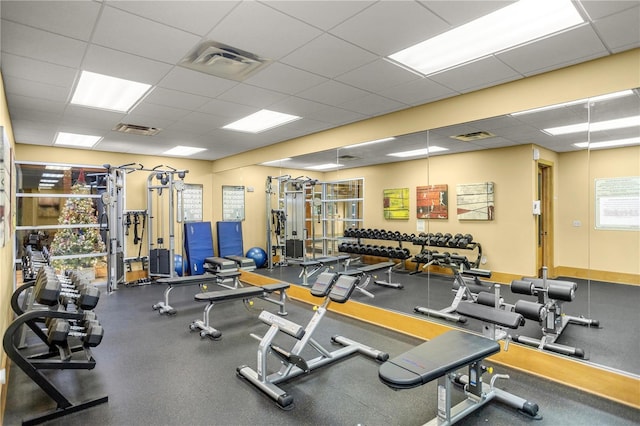 gym featuring visible vents and a drop ceiling