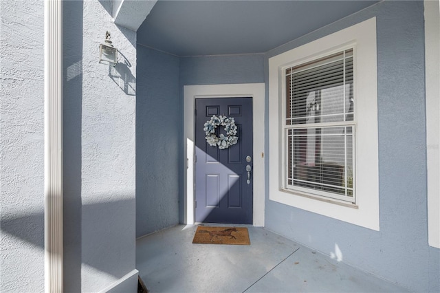 property entrance featuring stucco siding