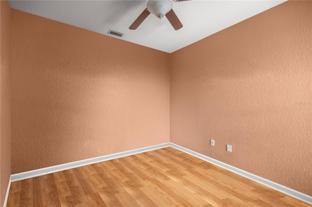 spare room featuring hardwood / wood-style flooring and ceiling fan