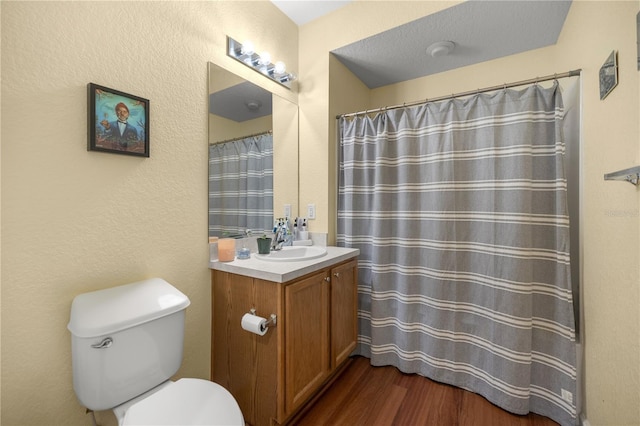 bathroom with vanity, toilet, and wood finished floors