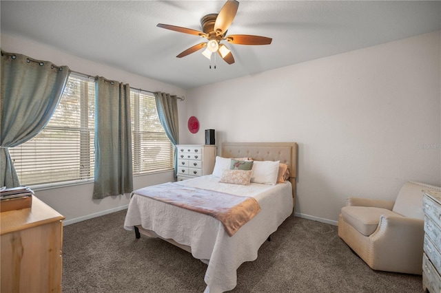 carpeted bedroom featuring baseboards and ceiling fan