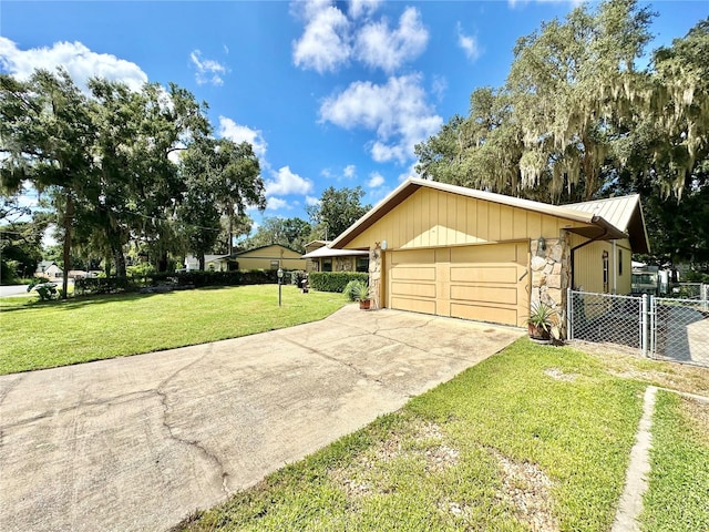 view of home's exterior with a garage and a yard