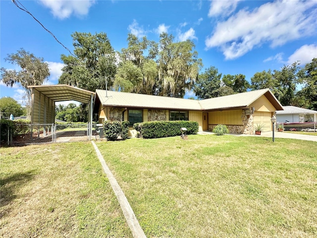 single story home with a garage, a front yard, and a carport