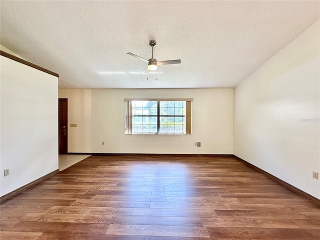 empty room with wood-type flooring, ceiling fan, and a textured ceiling