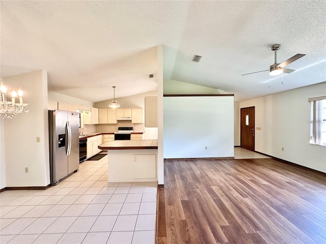 kitchen featuring white electric stove, kitchen peninsula, stainless steel fridge with ice dispenser, lofted ceiling, and light hardwood / wood-style floors