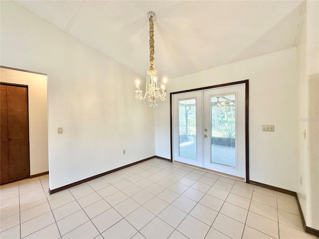 tiled empty room with french doors, a chandelier, and vaulted ceiling