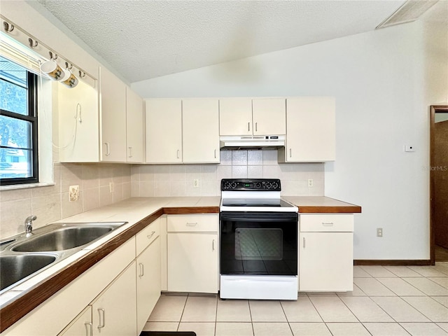 kitchen with backsplash, light tile patterned floors, sink, lofted ceiling, and white range with electric stovetop