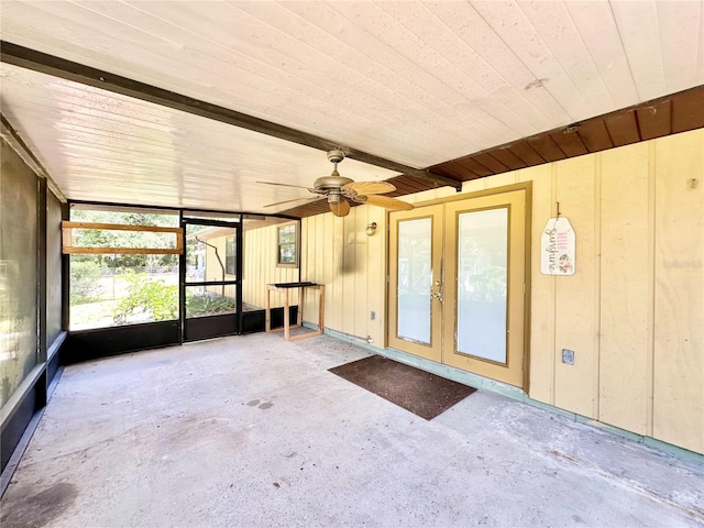 unfurnished sunroom featuring french doors and ceiling fan