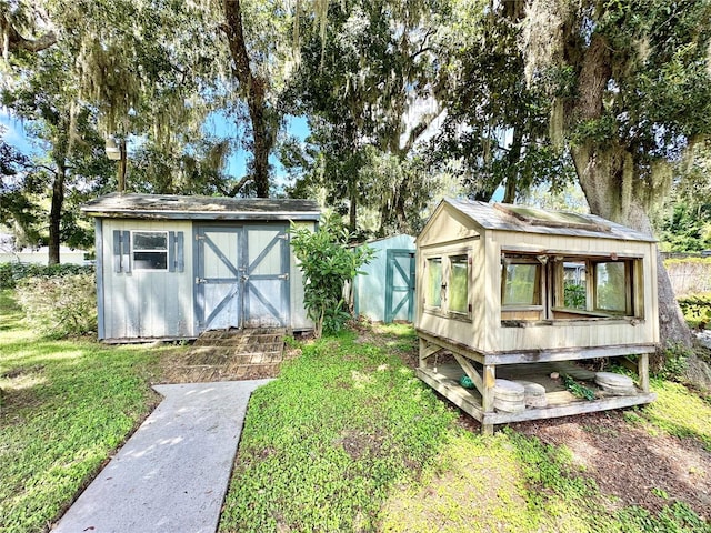 exterior space featuring a lawn and a shed