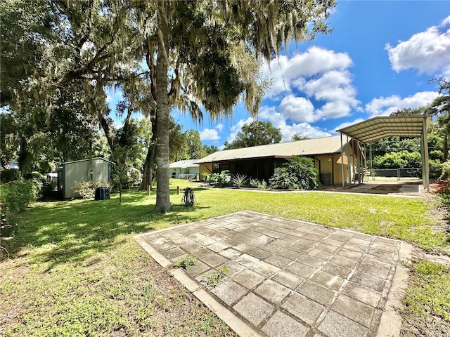 view of yard with an outbuilding and a carport