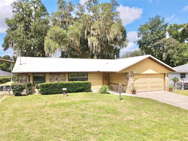 single story home with a garage and a front lawn