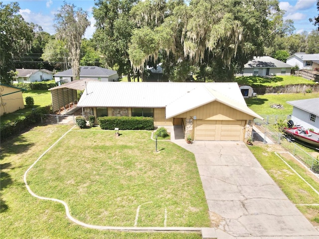 ranch-style house featuring a front yard and a garage