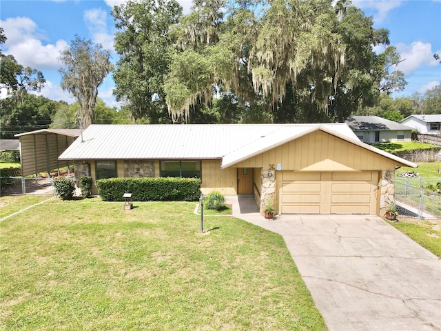 ranch-style home featuring a garage and a front yard