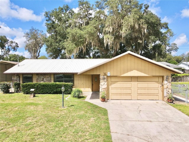 ranch-style home with a garage and a front yard