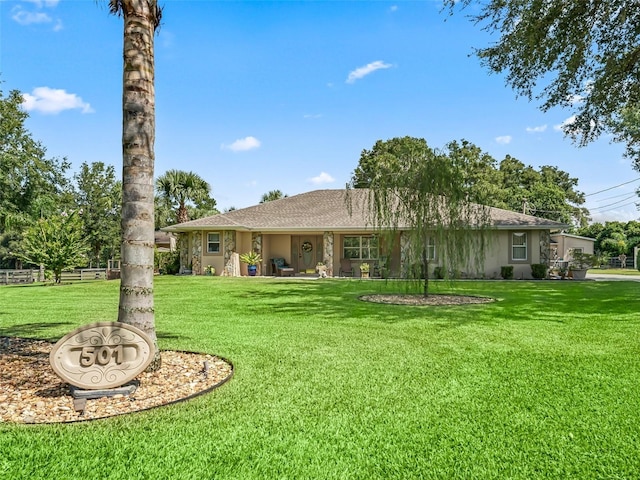 view of front of house featuring a front yard and stucco siding