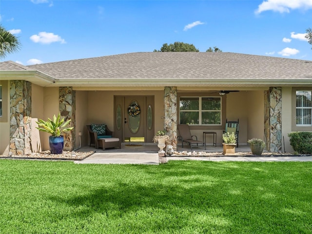 exterior space featuring a patio area, a yard, and ceiling fan