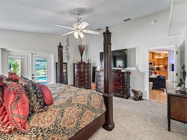 carpeted bedroom with ceiling fan, access to outside, and vaulted ceiling