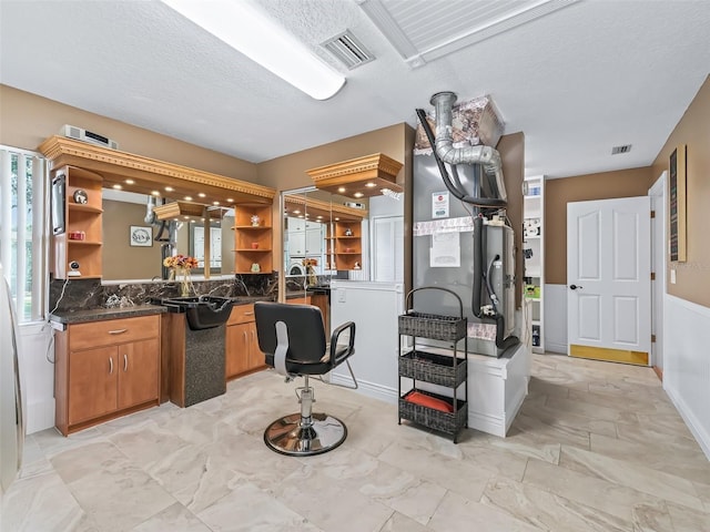 kitchen with brown cabinetry, visible vents, open shelves, and a textured ceiling