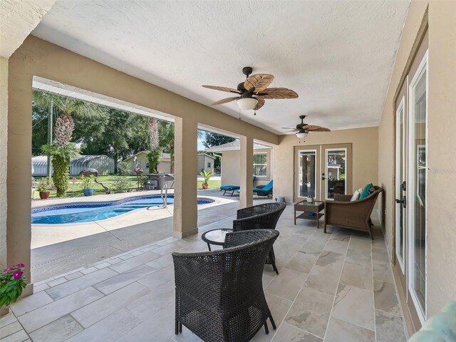 view of patio with ceiling fan and outdoor lounge area