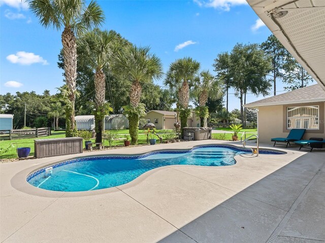 view of swimming pool with a hot tub and a patio