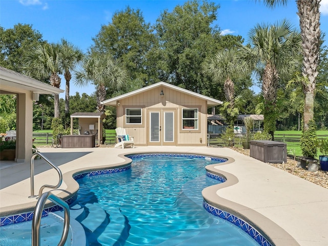 view of pool featuring an outdoor structure and a patio area