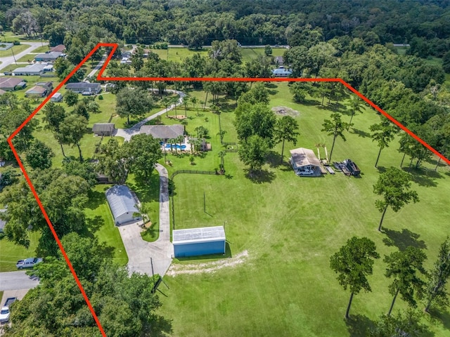 birds eye view of property featuring a forest view