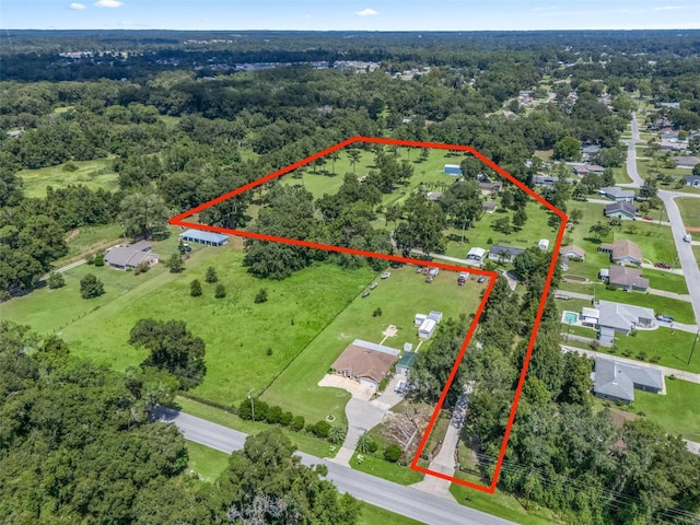 birds eye view of property featuring a view of trees