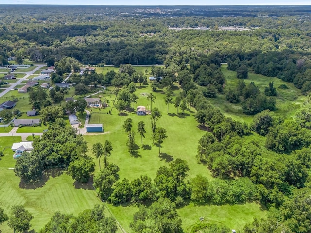 bird's eye view with a wooded view