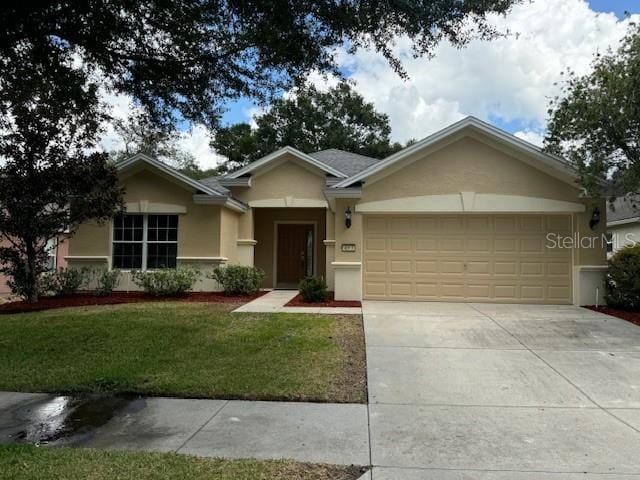 ranch-style house featuring a front lawn and a garage