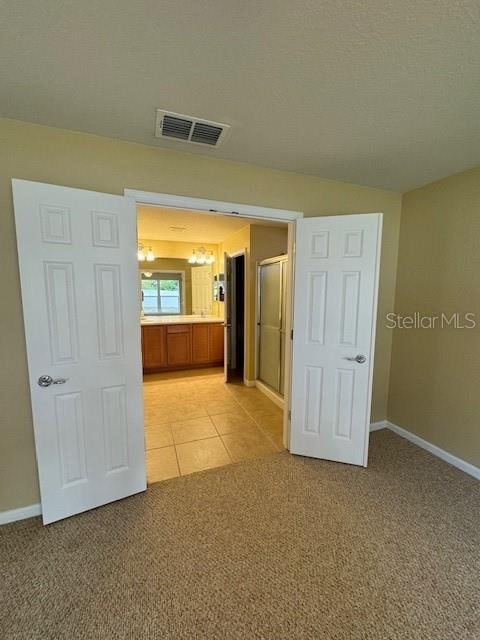 unfurnished room with light carpet