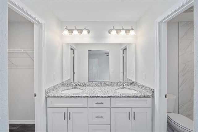 bathroom with hardwood / wood-style floors, toilet, and vanity