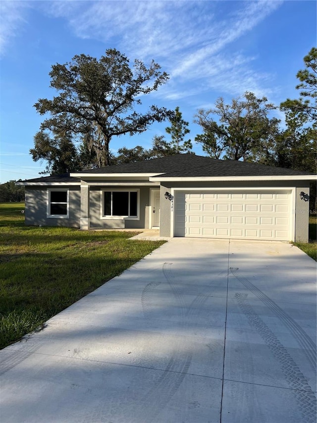 ranch-style home with a garage and a front yard