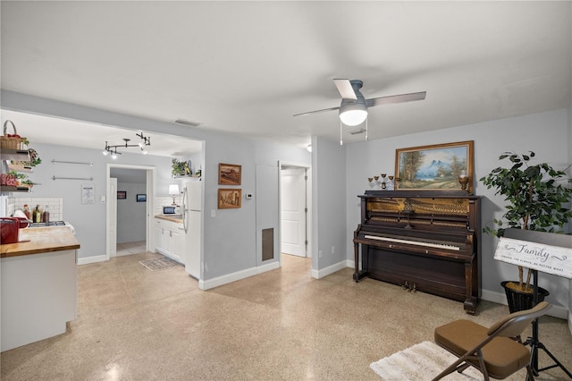 interior space with ceiling fan