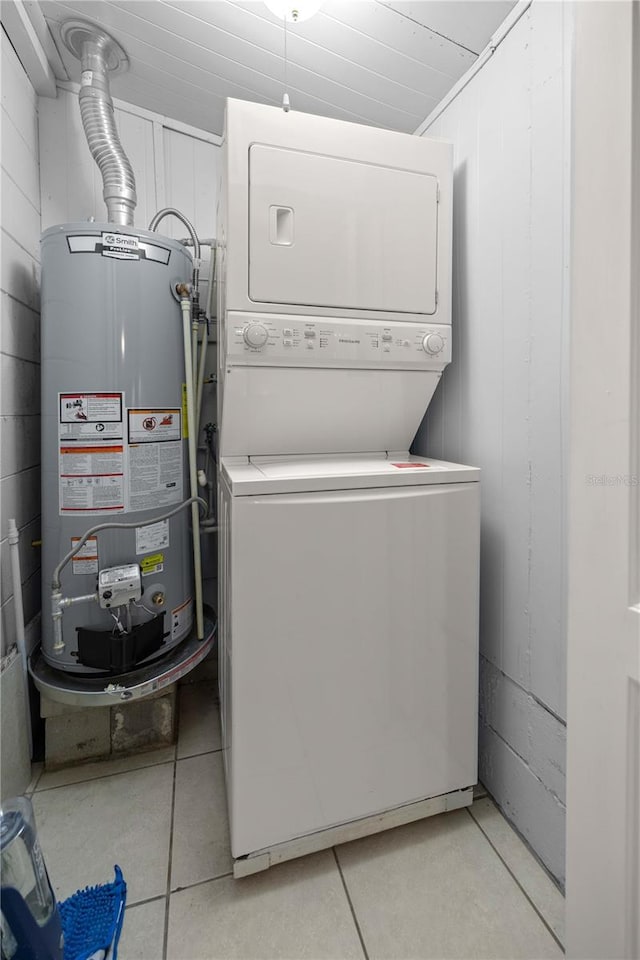 laundry room featuring stacked washer and dryer and water heater