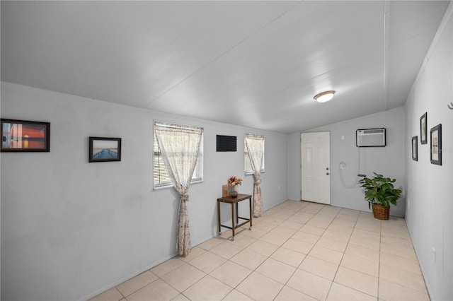 tiled foyer entrance with vaulted ceiling and a wall unit AC