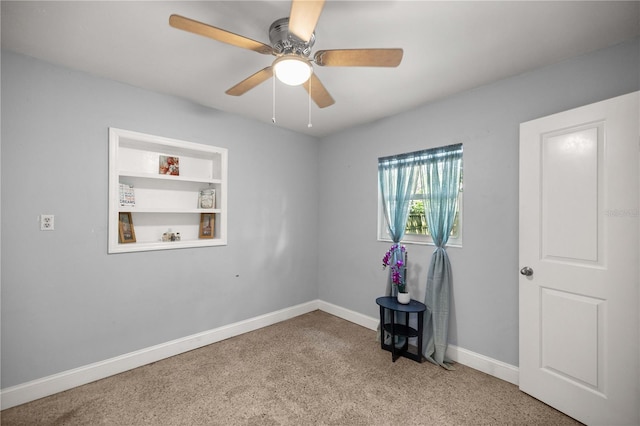 empty room with ceiling fan and carpet