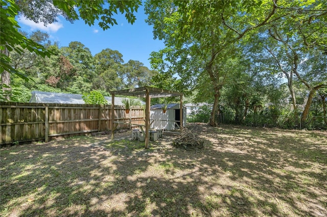 view of yard with a storage shed and a pergola