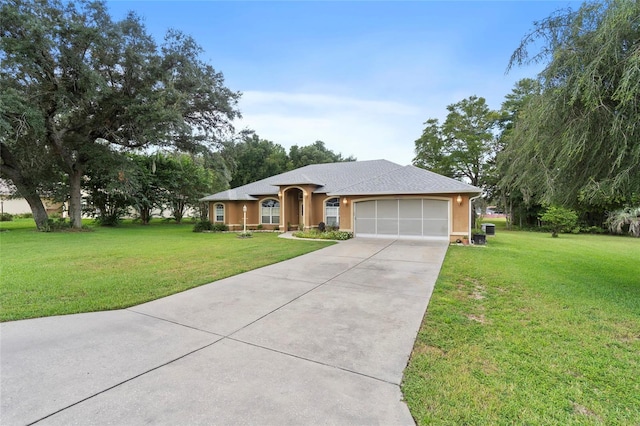 single story home featuring a garage and a front yard