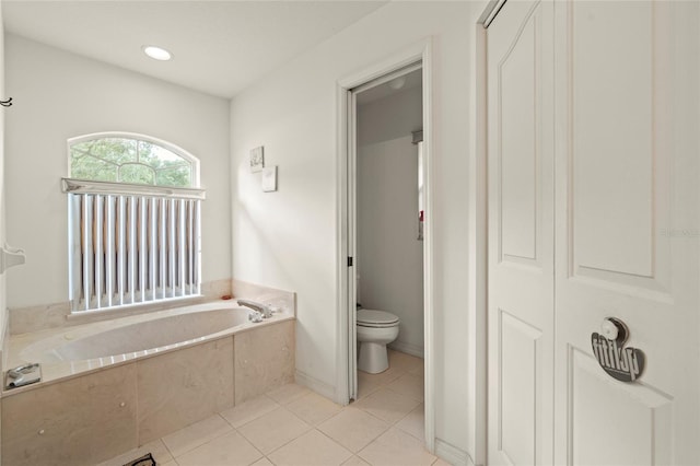 bathroom featuring toilet, a bathing tub, and tile patterned floors