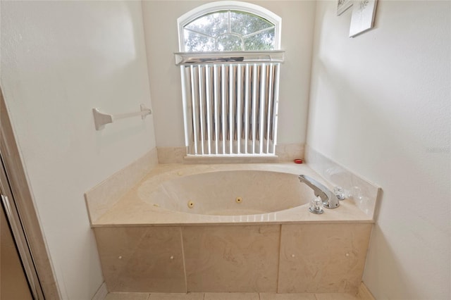 bathroom featuring a tub to relax in and tile patterned flooring