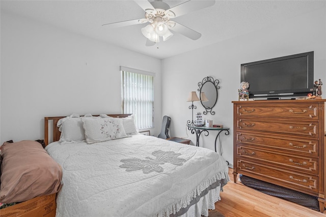 bedroom with hardwood / wood-style floors and ceiling fan