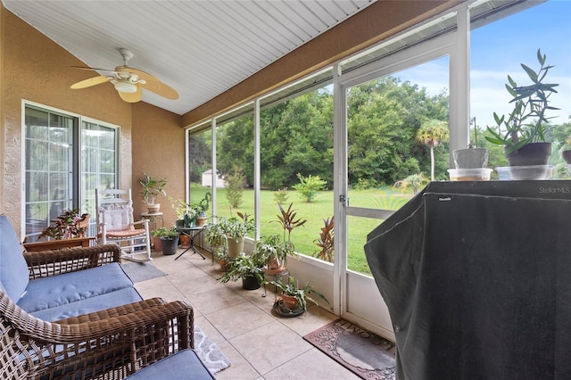 sunroom with ceiling fan and plenty of natural light