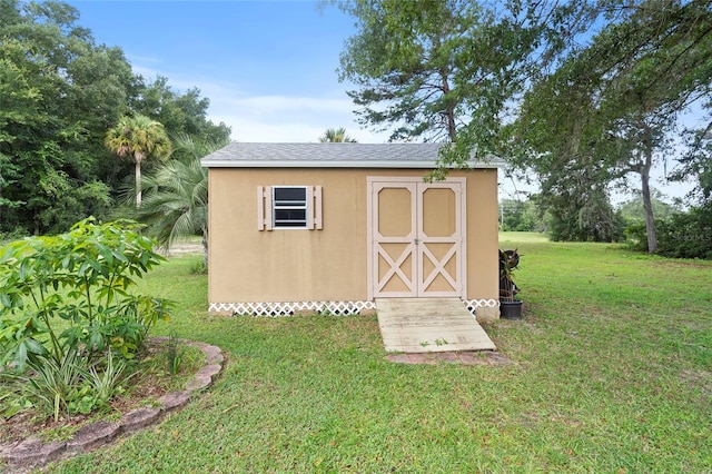 view of outbuilding with a yard