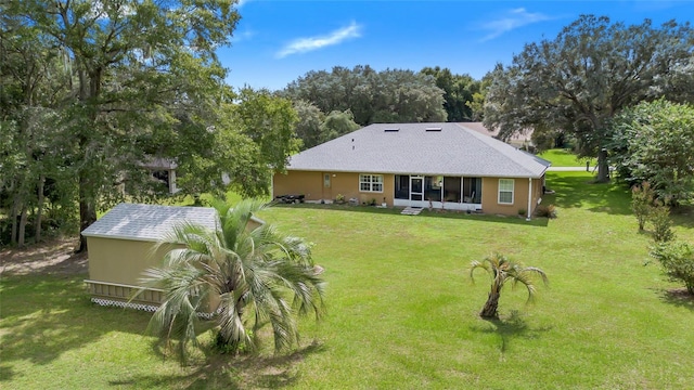 rear view of property featuring a yard