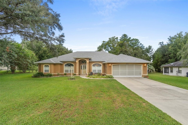 single story home featuring a garage and a front lawn