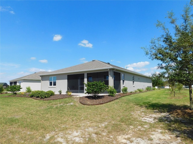 view of front of house featuring a sunroom and a front lawn